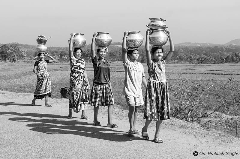 Heading home with headloads of drinking water from a distant traditional spring-based source in Khunti district, Jharkhand, India